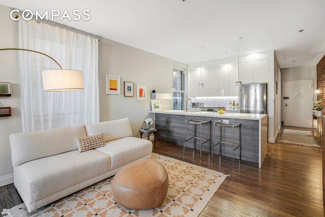 living room featuring dark wood-style floors and baseboards