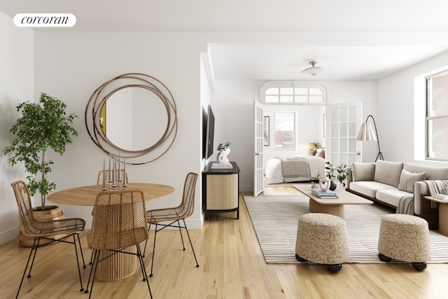 living area featuring baseboards, visible vents, and light wood-style floors