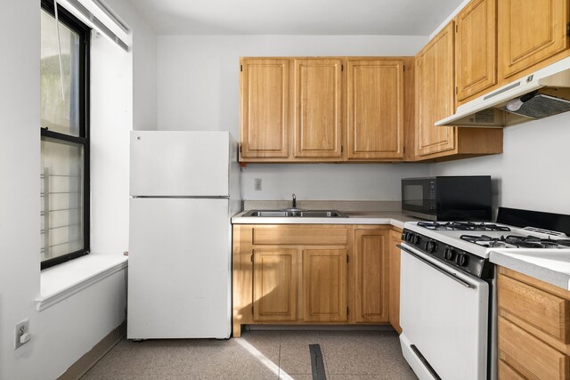 101 W 115th St Unit 2C, New York City, NY 10026 - kitchen with a sink, light countertops, under cabinet range hood, and white appliances
