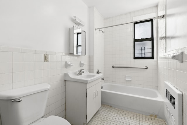 full bath featuring heating unit, toilet, vanity, tile walls, and tile patterned floors