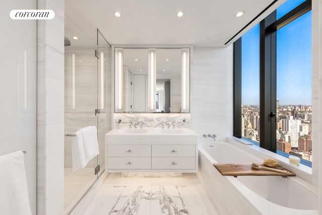 bathroom featuring recessed lighting, a shower stall, a bath, and vanity