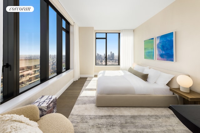 bedroom featuring wood finished floors and baseboards