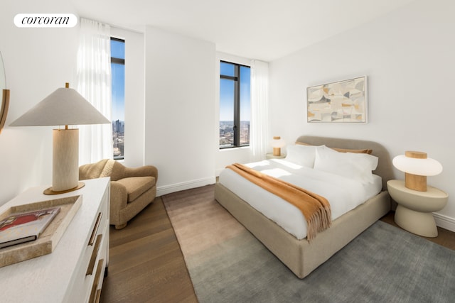 bedroom featuring baseboards, visible vents, and wood finished floors