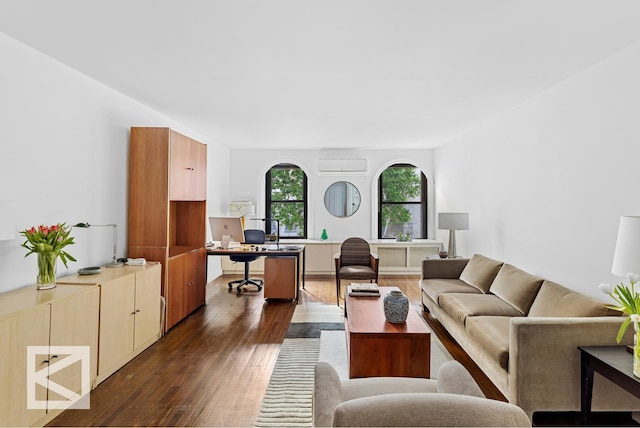 living area with a wall mounted air conditioner and dark wood-type flooring