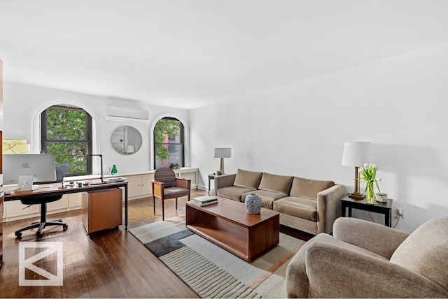 living room featuring wood finished floors, a wealth of natural light, and a wall mounted AC