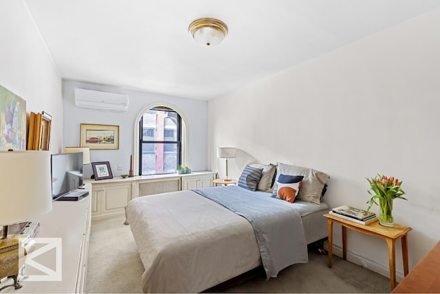 bedroom with a wall mounted AC and light carpet