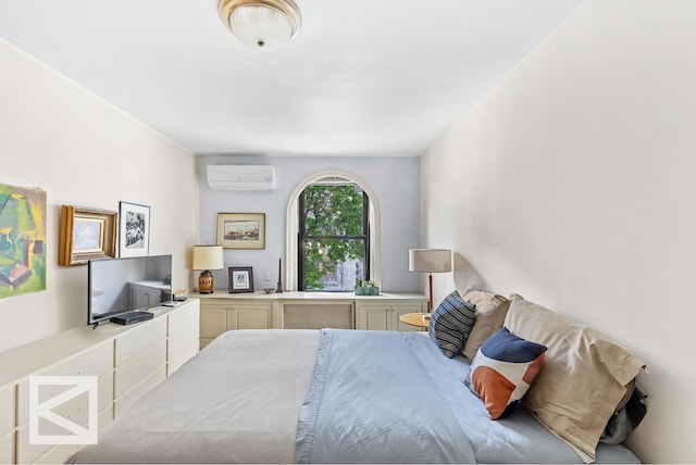 bedroom featuring an AC wall unit