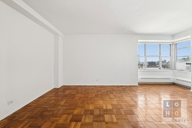 spare room featuring radiator heating unit