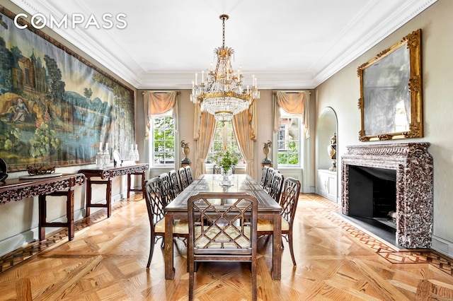 dining room with crown molding, a fireplace, and a chandelier