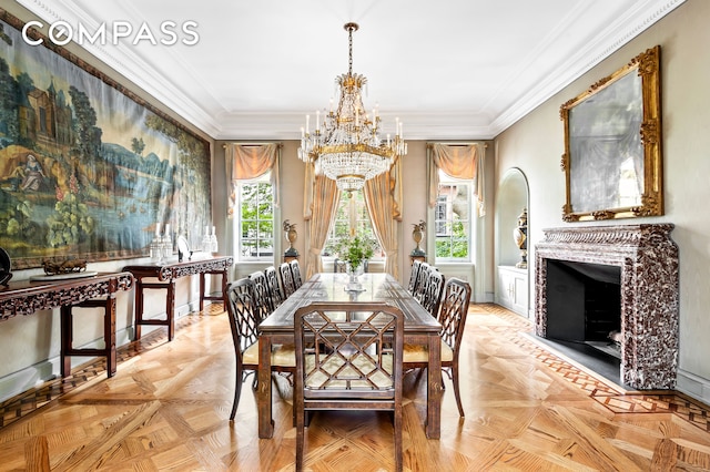 dining space featuring a chandelier, ornamental molding, and a fireplace