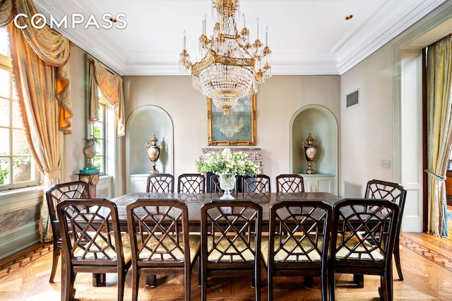 dining area with arched walkways, visible vents, an inviting chandelier, and ornamental molding