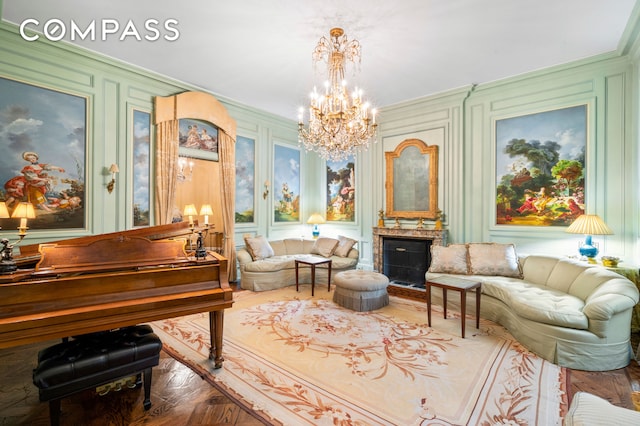 sitting room featuring an inviting chandelier, ornamental molding, and a fireplace