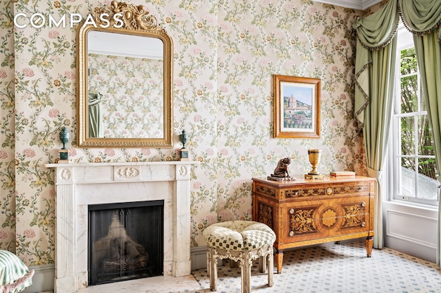 living area featuring a fireplace and wallpapered walls