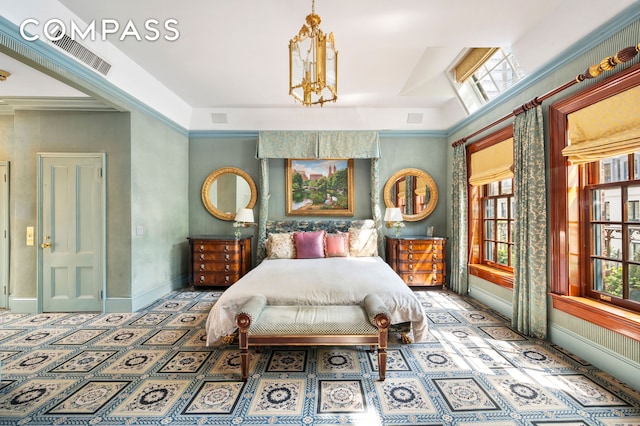 bedroom featuring a notable chandelier, baseboards, visible vents, and multiple windows