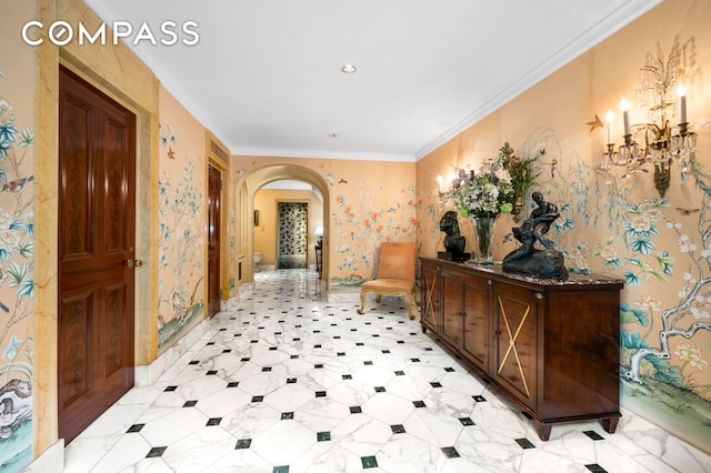 hallway with arched walkways, ornamental molding, and wallpapered walls