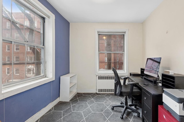 office area with radiator heating unit and baseboards