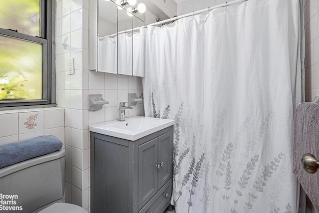 420 E 55th St Unit 11M, New York City, NY 10022 - full bathroom featuring vanity, tile walls, and curtained shower