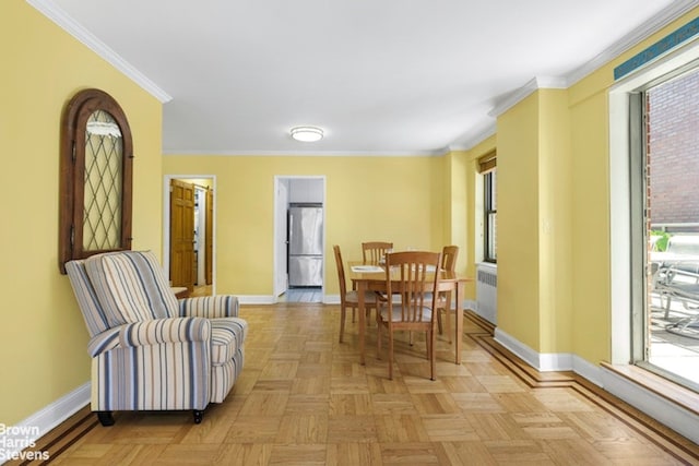 dining area with crown molding, plenty of natural light, and baseboards