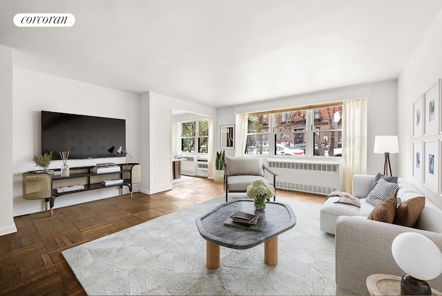 living room featuring visible vents and radiator