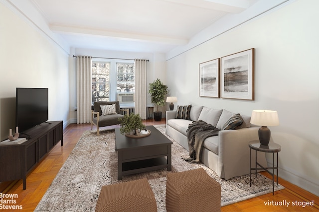 living area featuring beam ceiling and baseboards