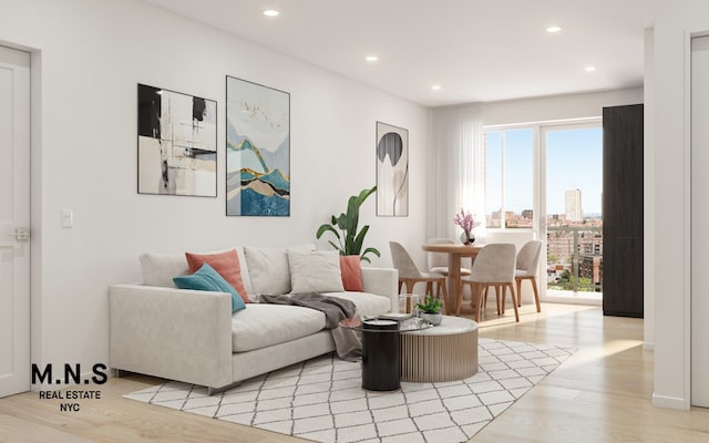 living area with light wood-type flooring, a view of city, and recessed lighting