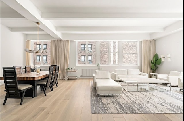 living area featuring light wood-type flooring, a chandelier, and beamed ceiling