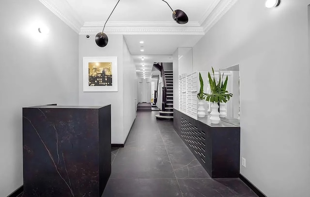 corridor with crown molding, stairs, and baseboards