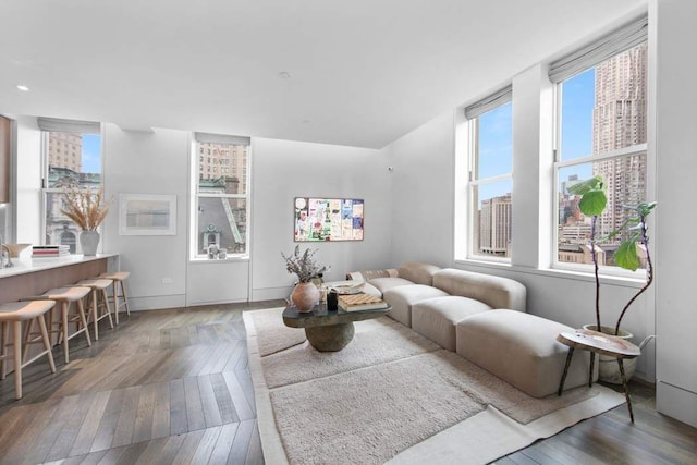 living area with a view of city and wood finished floors