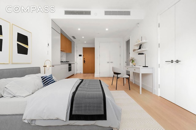 bedroom with recessed lighting, visible vents, and light wood-style floors