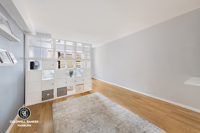 bedroom featuring baseboards and wood finished floors