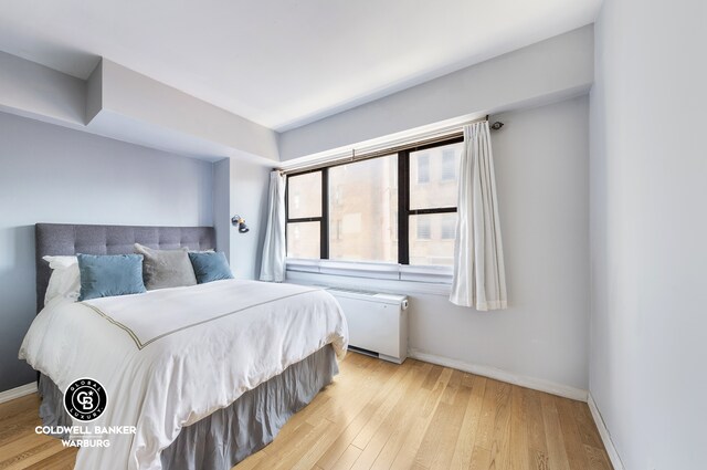 7 E 14th St Unit 1625, New York City, NY 10003 - bedroom featuring light wood-style flooring, baseboards, and radiator