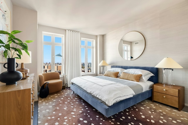 bedroom with visible vents and carpet