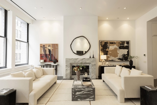 living room featuring recessed lighting and a high end fireplace