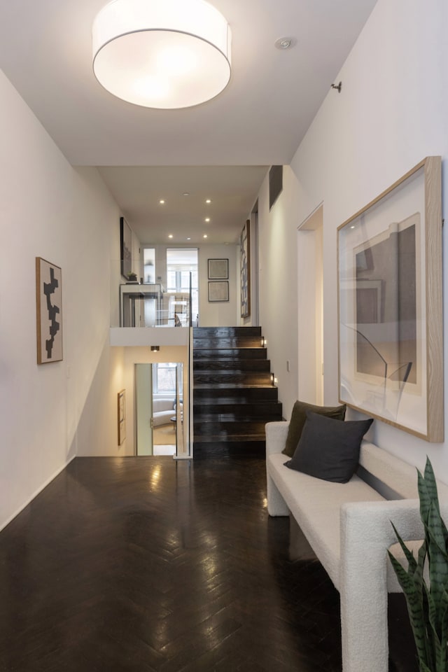 hall featuring dark wood-style floors, recessed lighting, and stairs