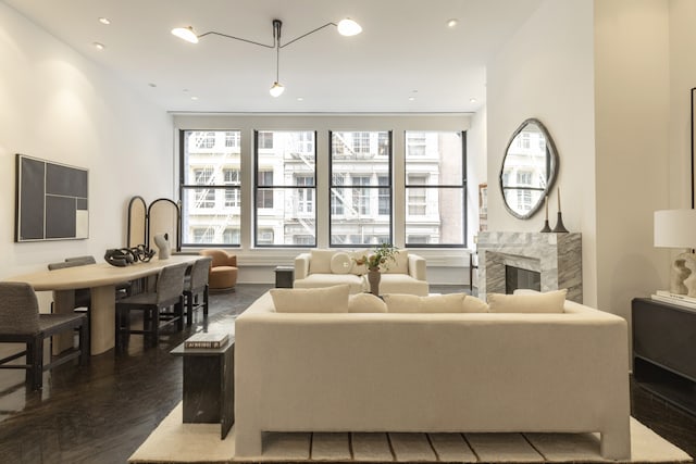 living area with dark wood finished floors, recessed lighting, and a premium fireplace