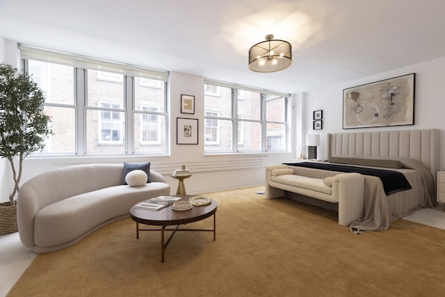 carpeted bedroom with an inviting chandelier