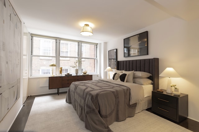 bedroom with baseboards and wood finished floors