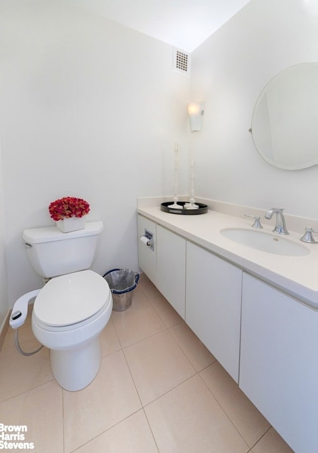 303 E 57th St Unit 32C, New York City, NY 10022 - bathroom featuring tile patterned flooring, visible vents, toilet, and vanity