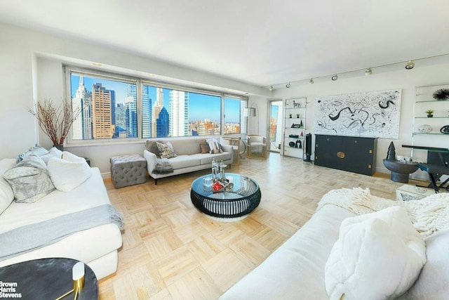 living area featuring built in shelves, a city view, and baseboards