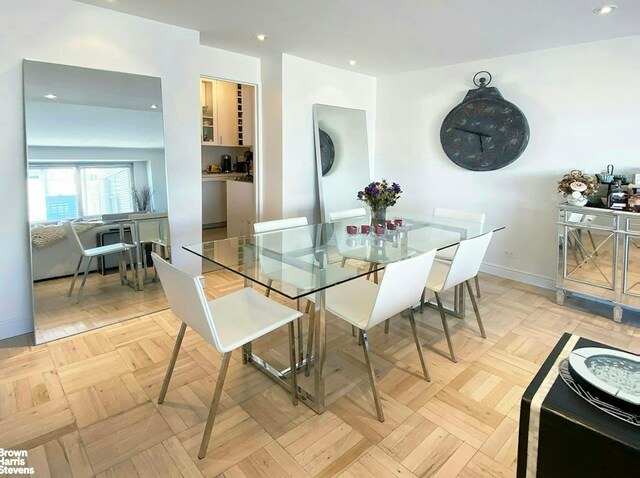 303 E 57th St Unit 32C, New York City, NY 10022 - dining space with baseboards and recessed lighting