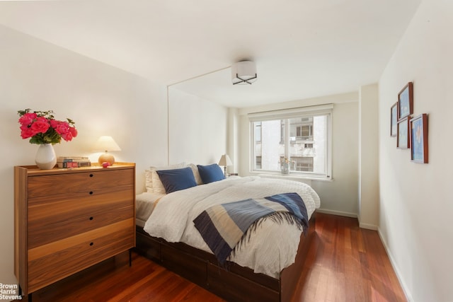301 E 22nd St Unit 7S, New York City, NY 10010 - bedroom featuring baseboards and wood finished floors