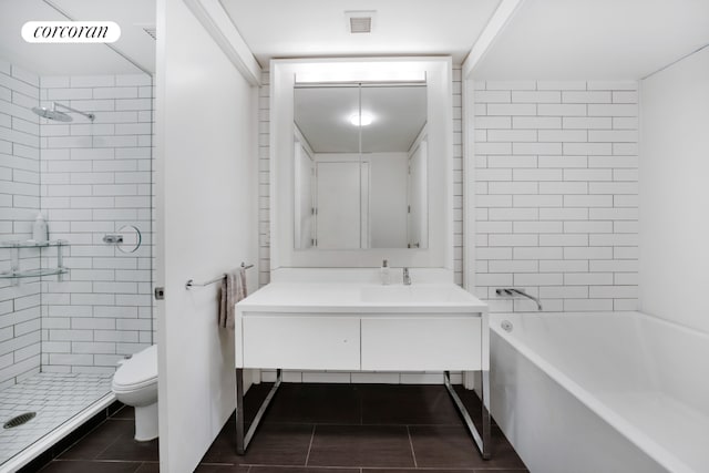 bathroom with toilet, visible vents, a tile shower, and vanity