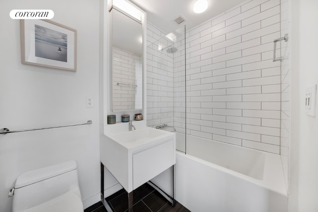 bathroom with shower / washtub combination, visible vents, vanity, and toilet