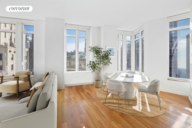 dining room with baseboards, visible vents, and wood finished floors