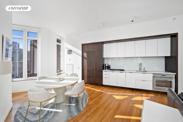 kitchen featuring white cabinetry, stainless steel oven, and modern cabinets