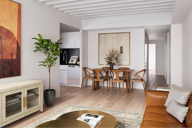 living room featuring beamed ceiling and light wood finished floors