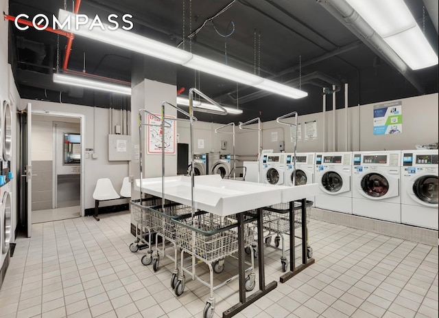 common laundry area with tile patterned flooring and separate washer and dryer