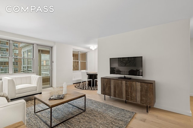 living area with wood finished floors and baseboards