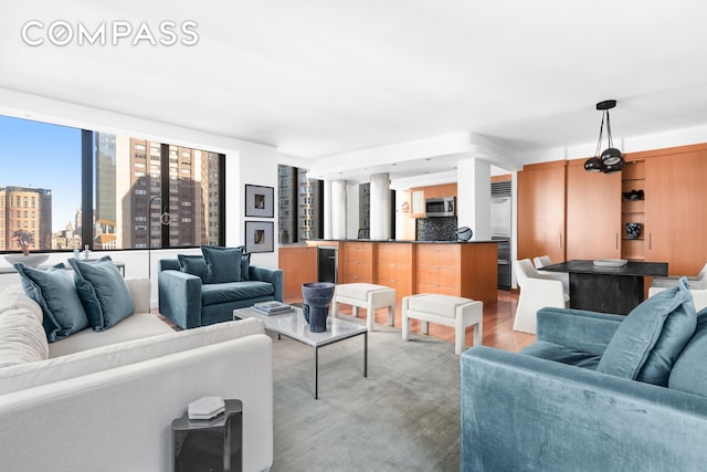 living room with a view of city, light wood-style flooring, and wine cooler