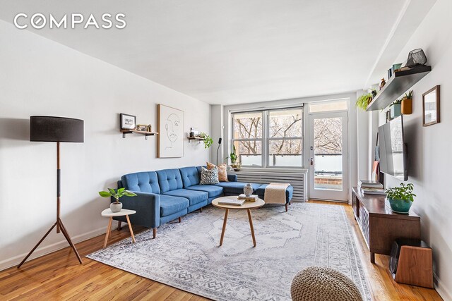 living area with wood finished floors and baseboards